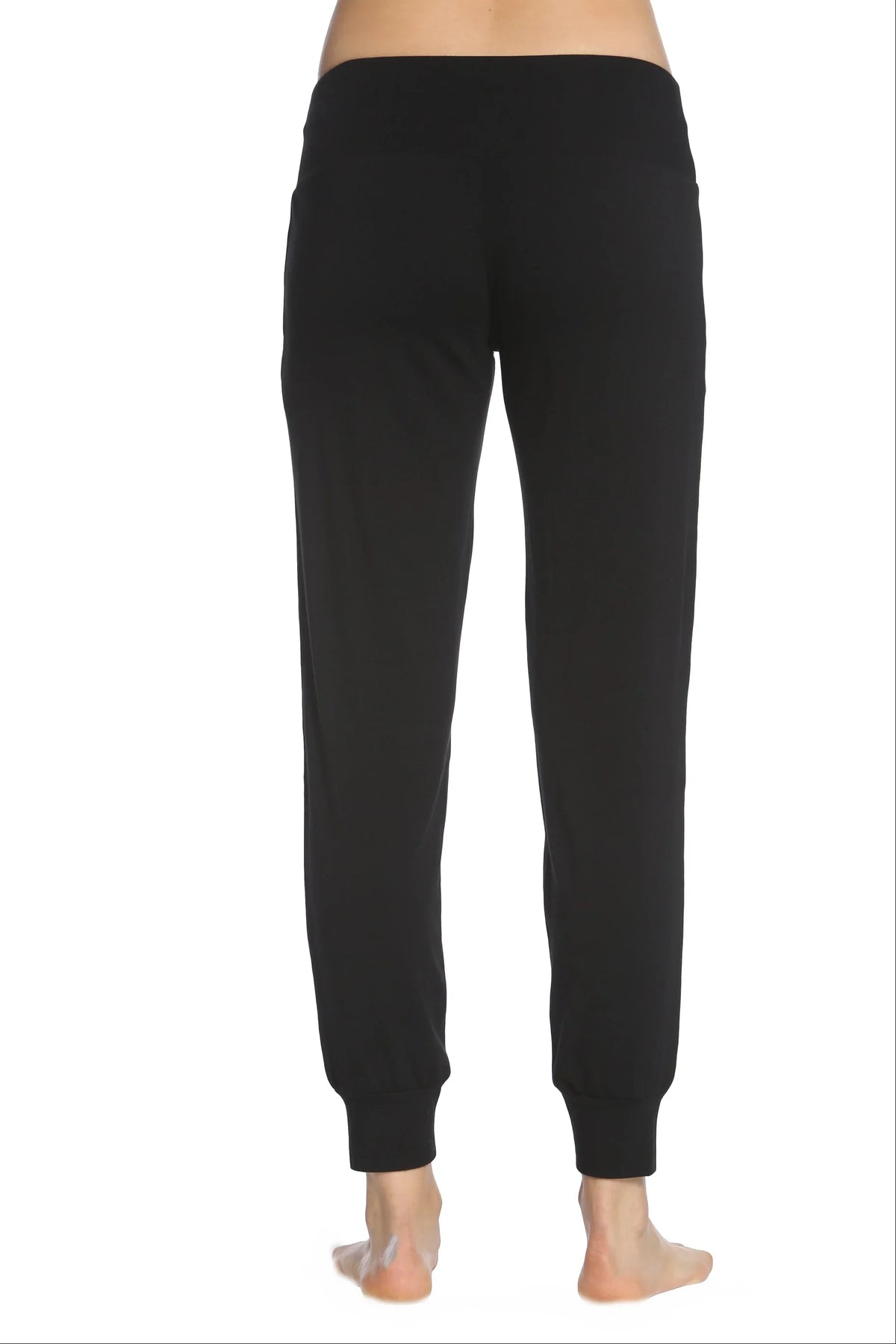 Back view of black Pima cotton lounge pants with wide waistband and cuffed ankles on model