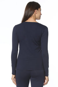 Woman wearing navy long sleeve loungewear top and pants set, back view