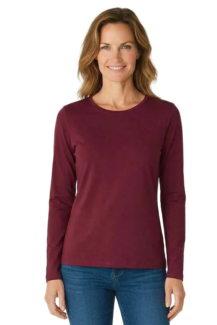 Woman wearing a long sleeve burgundy Pima cotton loungewear tee and blue jeans