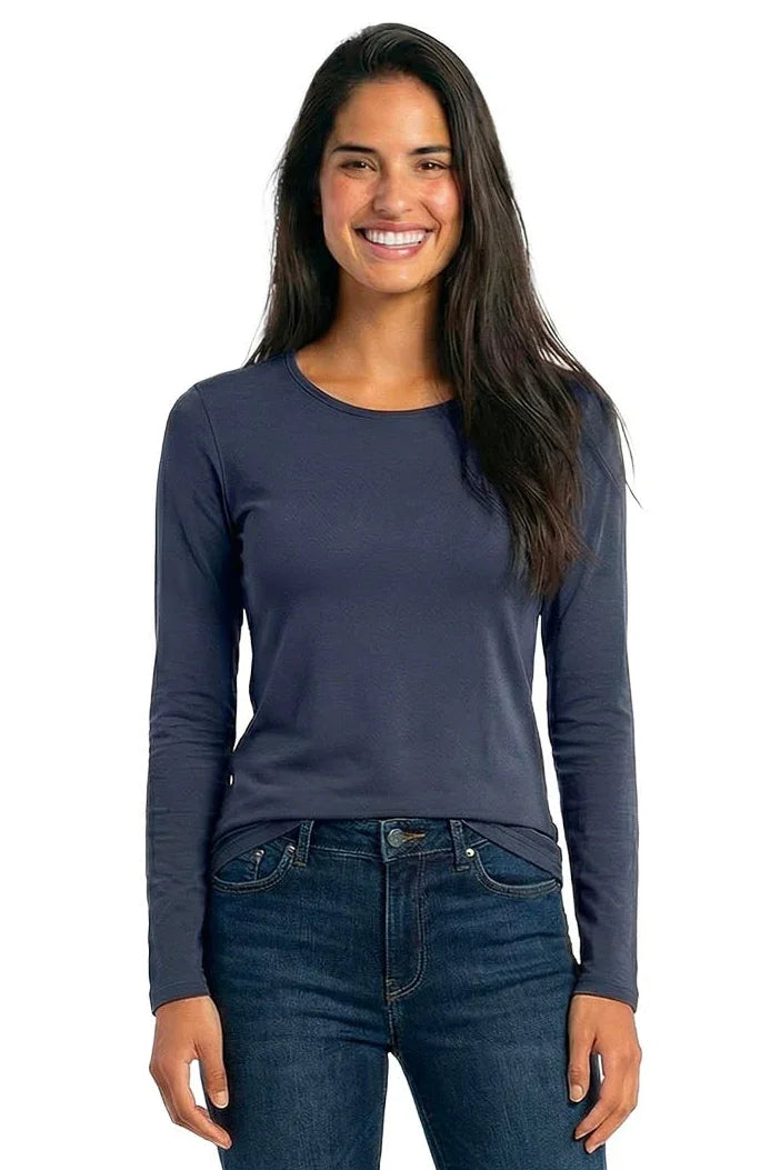 Woman wearing a steel blue long sleeve Pima cotton lounge top and dark denim jeans