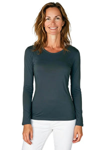 Woman wearing a steel blue long sleeve Pima cotton loungewear tee and white pants