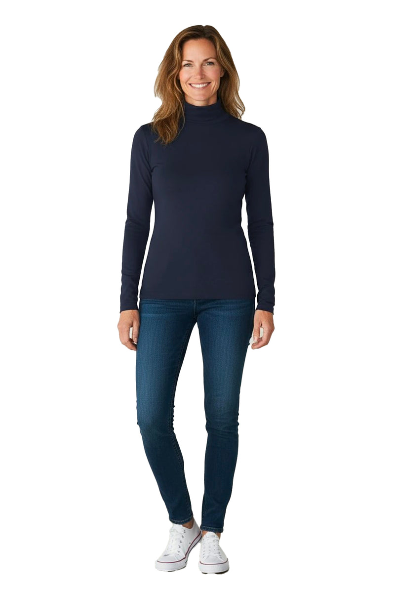 Woman wearing a navy turtleneck t-shirt, blue jeans, and white sneakers on a white background