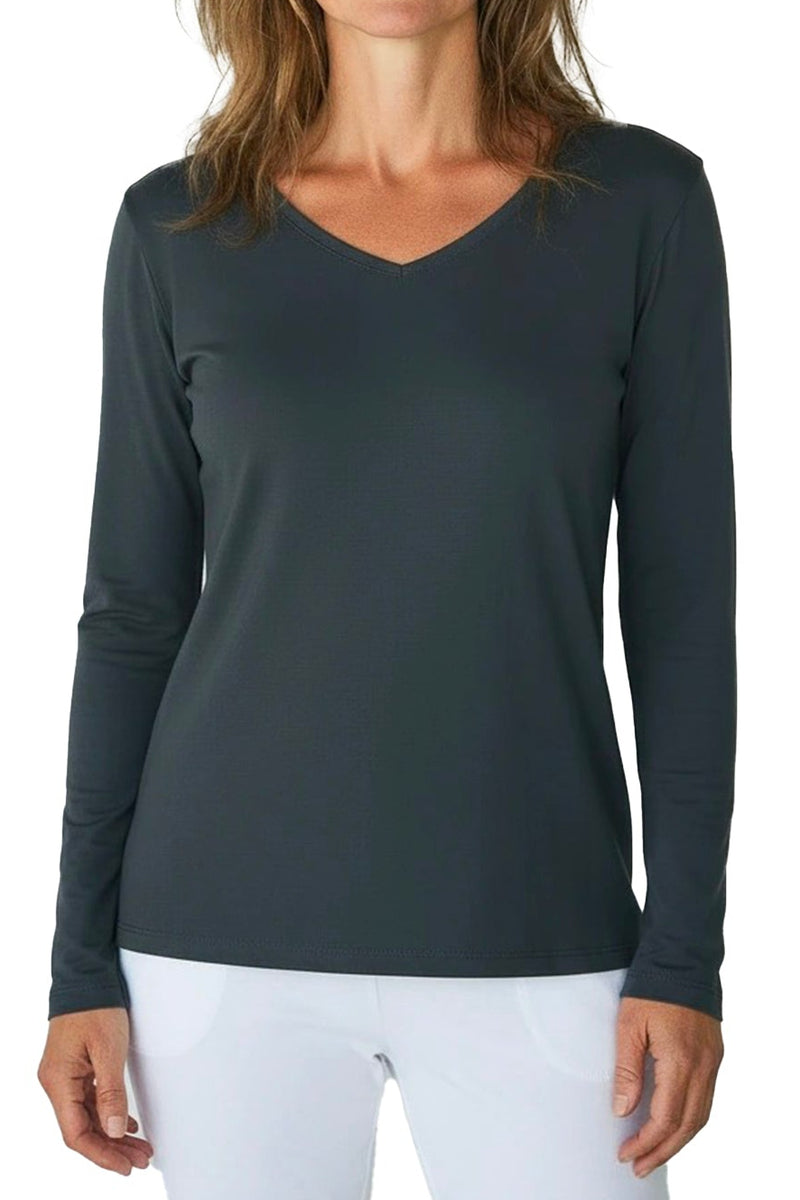 Woman wearing a dark gray long-sleeve top and white pants on a white background