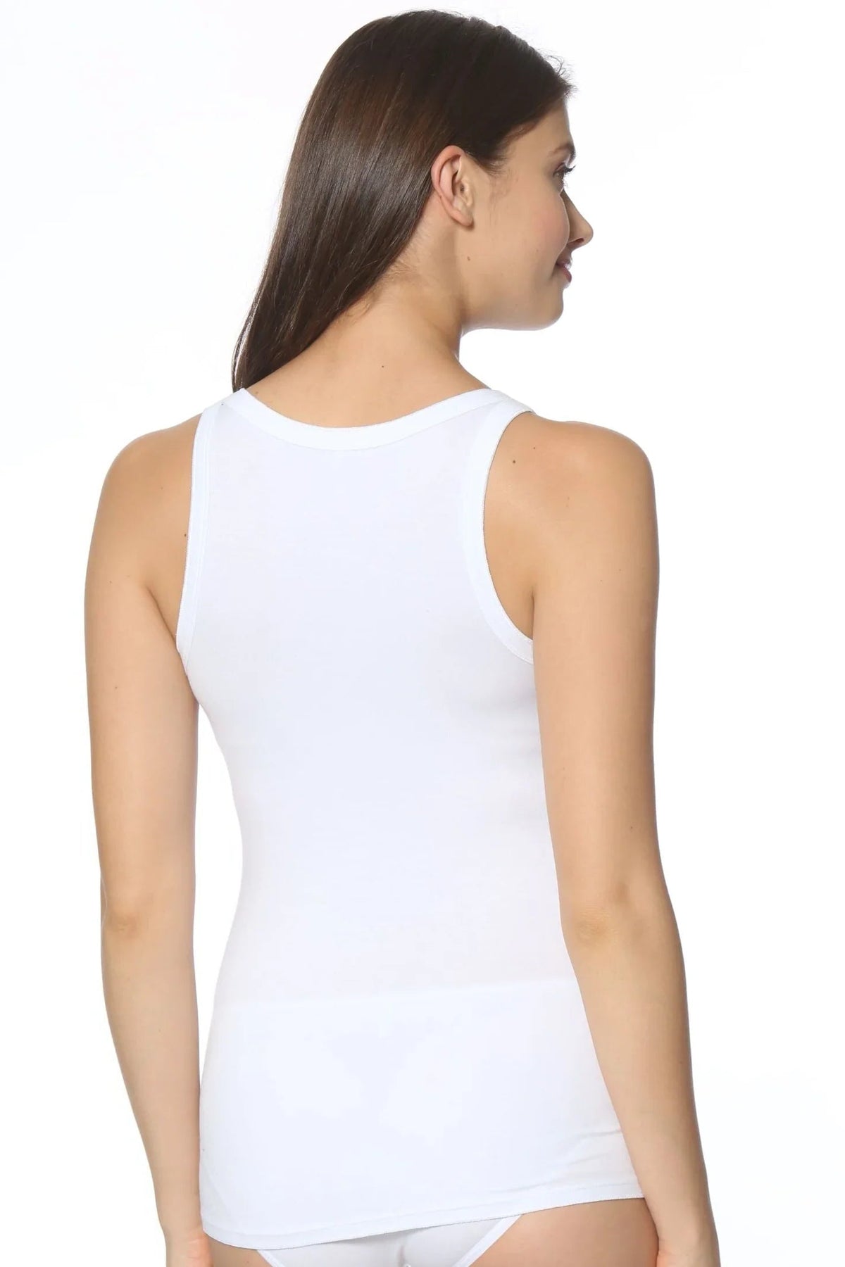 Woman wearing a white Pima cotton tank top and underwear, shown from the back