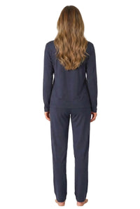 Woman in navy blue long sleeve loungewear set, seen from the back, on white background