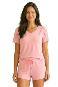 Woman wearing soft pink Pima cotton loungewear set with V-neck tee and drawstring shorts