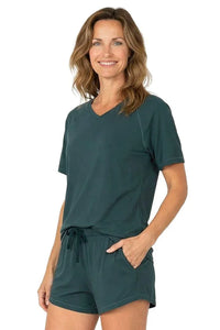 Woman wearing dark green Pima cotton loungewear short sleeve tee and drawstring shorts