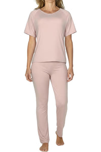 Woman wearing shell pink short-sleeve top and matching long pants loungewear set