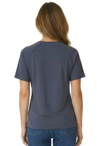 Woman wearing a steel blue short sleeve loungewear tee and blue jeans, back view