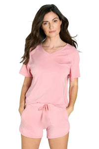 Woman wearing light pink short sleeve Pima cotton lounge set with drawstring shorts