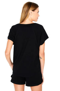 Woman wearing black Pima cotton loungewear tee and shorts, back view