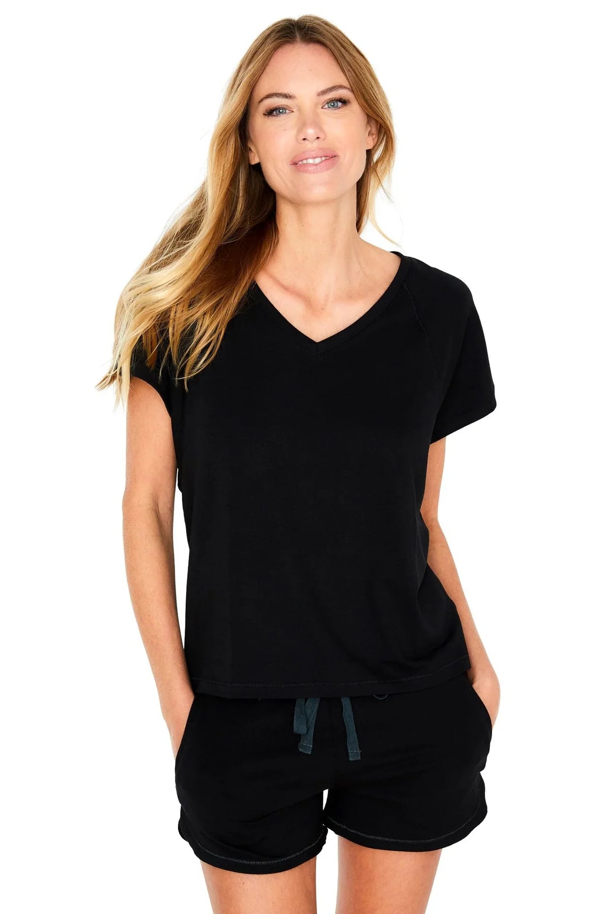Woman wearing black Pima cotton loungewear set with short sleeve top and drawstring shorts