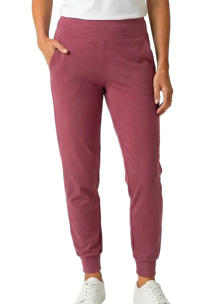 Rosewood pink jogger lounge pants with pockets, tapered legs, and white sneakers