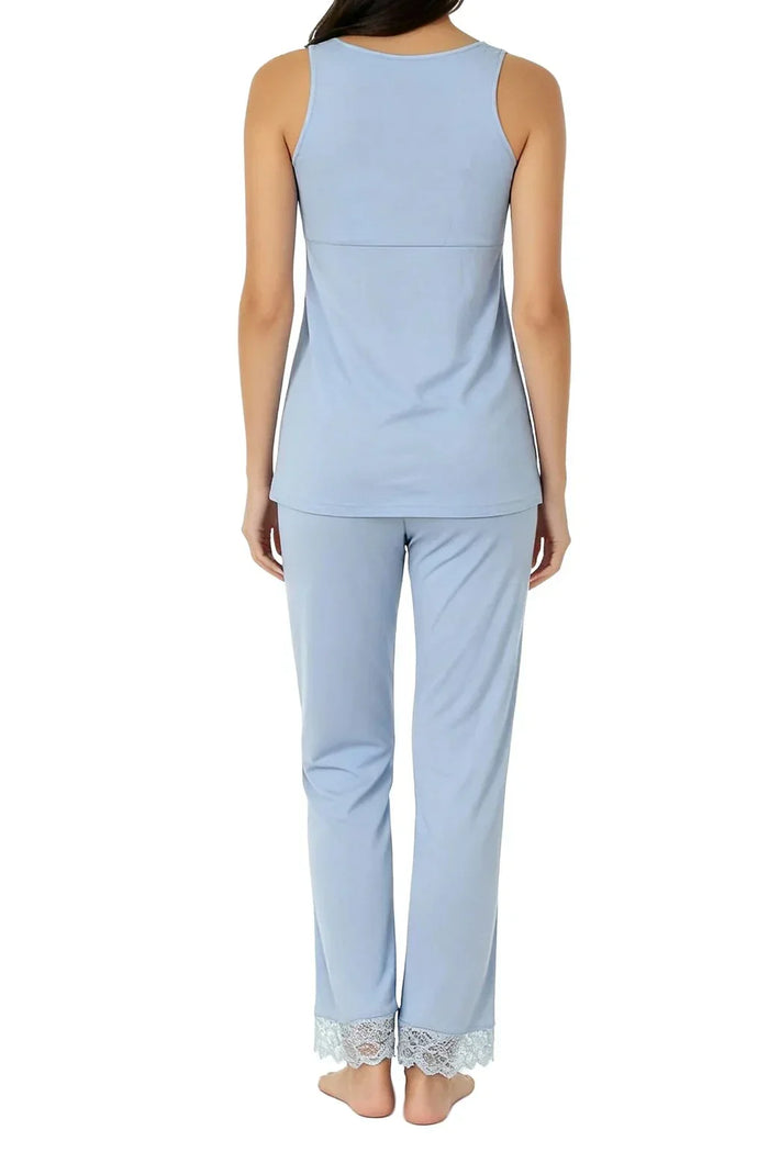 Woman wearing light blue sleeveless loungewear set with lace trim pants, back view