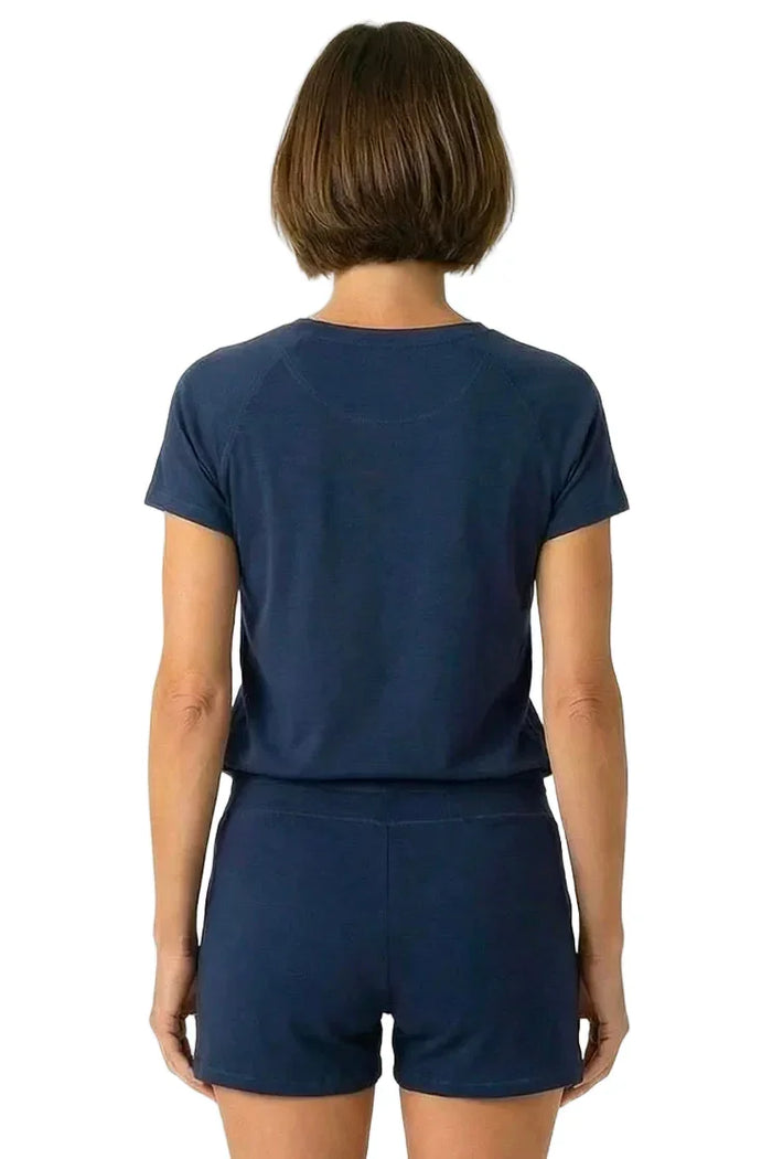 Woman wearing midnight blue Pima cotton short sleeve loungewear tee and shorts, back view
