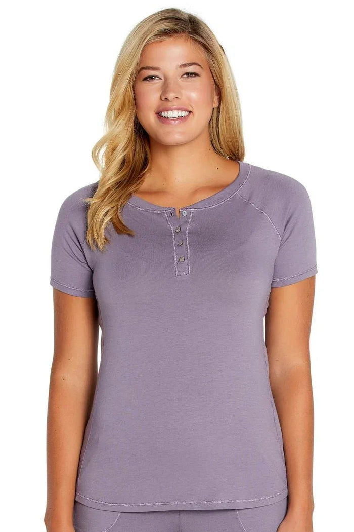 Woman wearing a Twelve Eighty Eight Olivia short sleeve purple Henley tee.