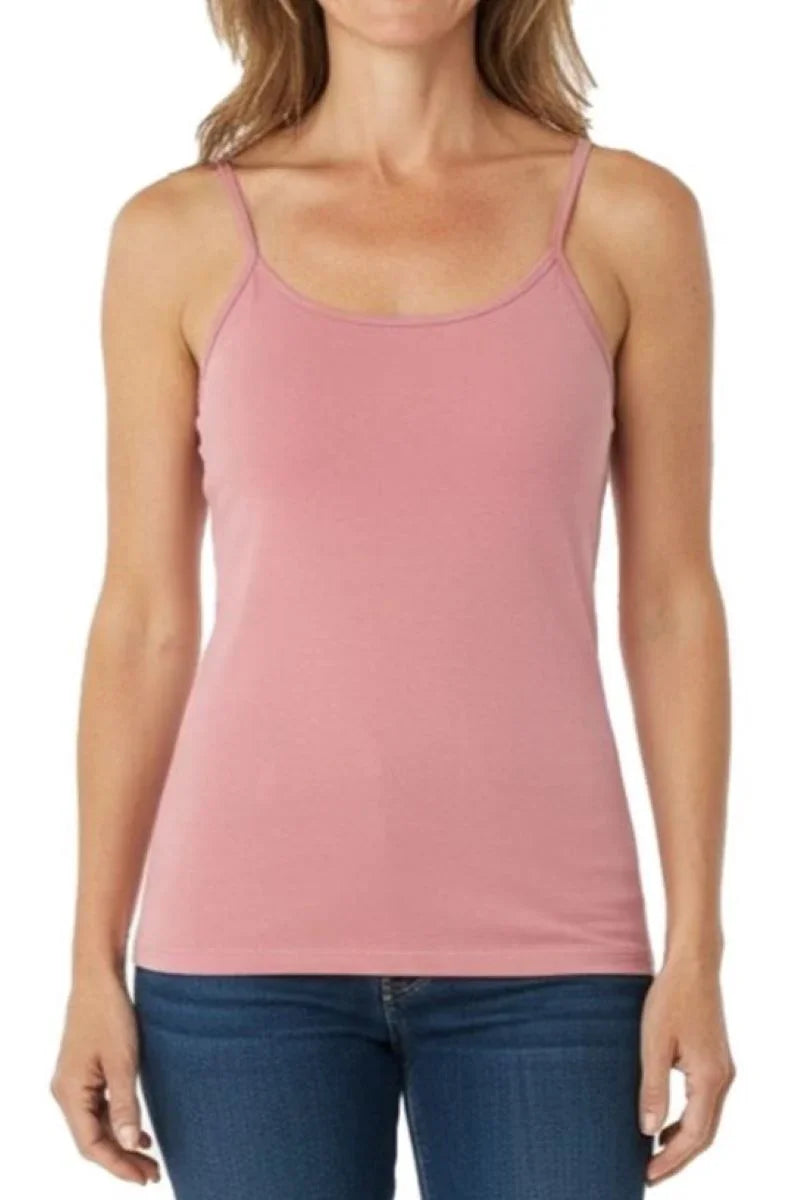 Woman wearing a silky rose pink spaghetti strap tank top with blue jeans