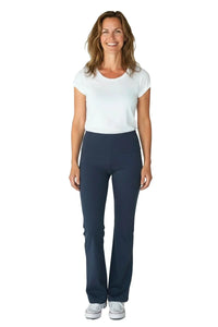 Smiling woman wearing white t-shirt and steel blue yoga pants with sneakers on white background