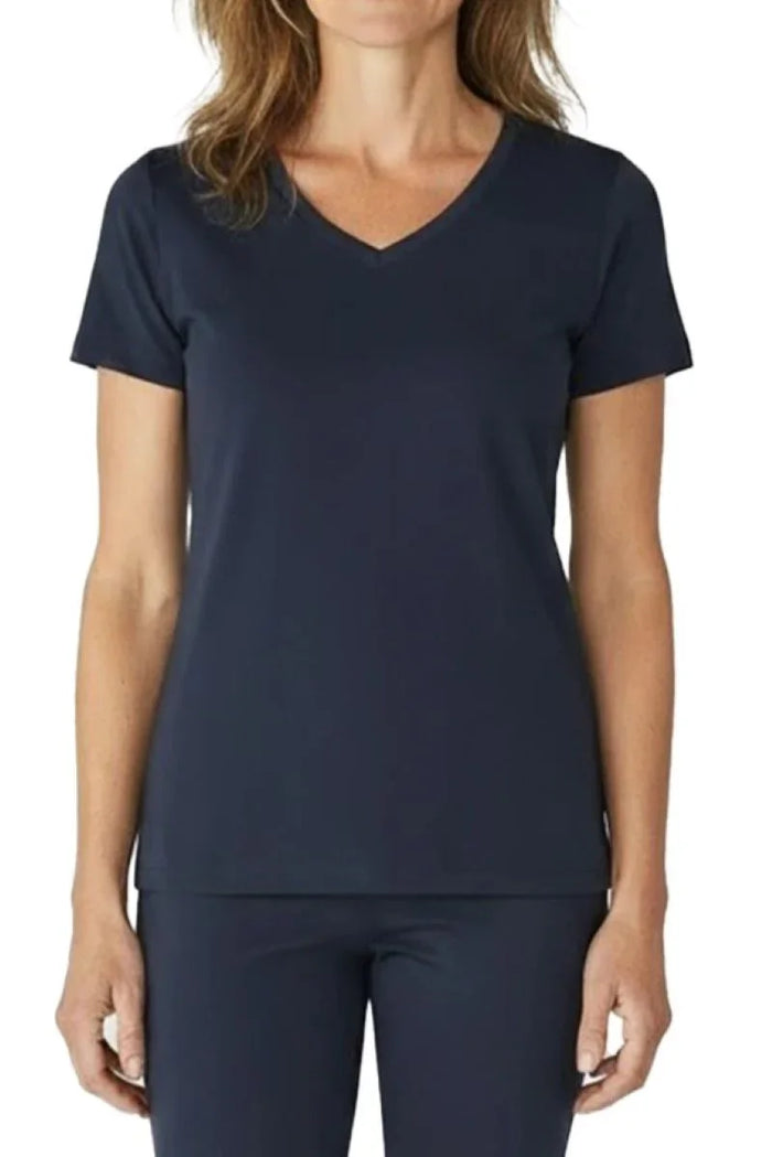 Woman wearing steel blue short-sleeve V-neck scrub top with matching pants on white background