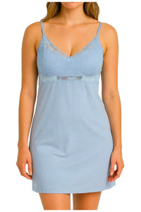 Woman wearing light blue lace trim nightdress with thin straps on white background