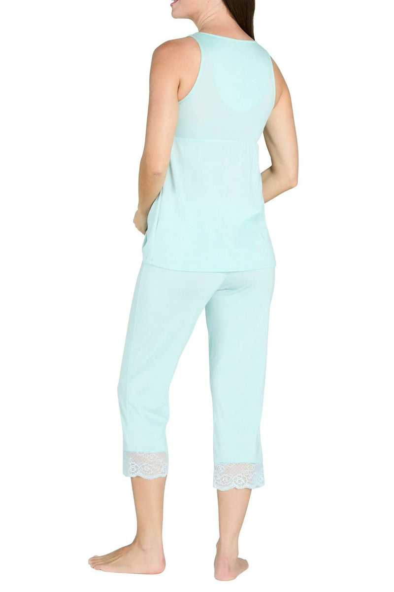 Woman in light blue sleeveless tank top and cropped pants with lace trim on white background