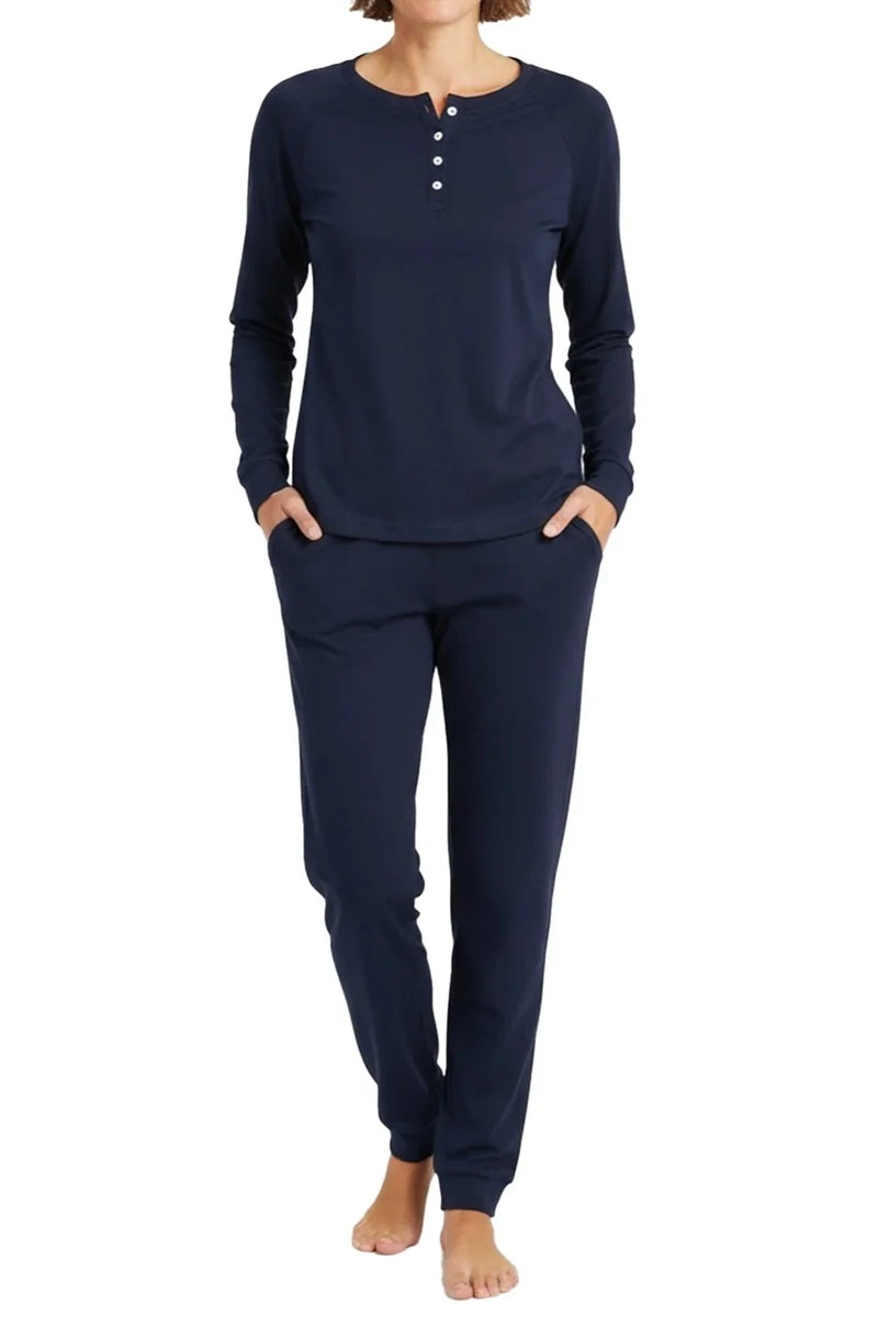Woman wearing midnight blue long-sleeve Henley top and matching jogger pants loungewear set