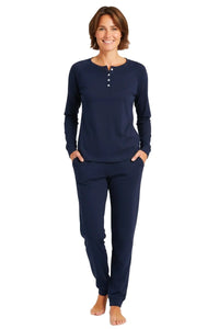 Smiling woman wearing midnight blue long sleeve henley top and matching jogger pants loungewear