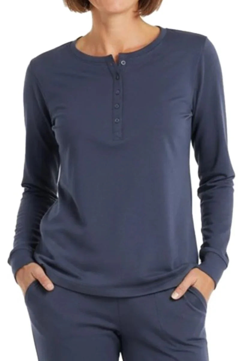 Woman wearing steel blue long-sleeve henley shirt with button placket and matching pants