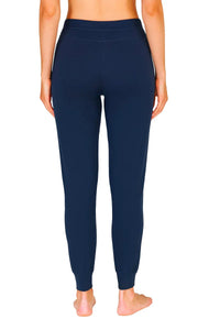 Back view of woman wearing midnight blue slim-fit jogger pants with elastic cuffs and waistband