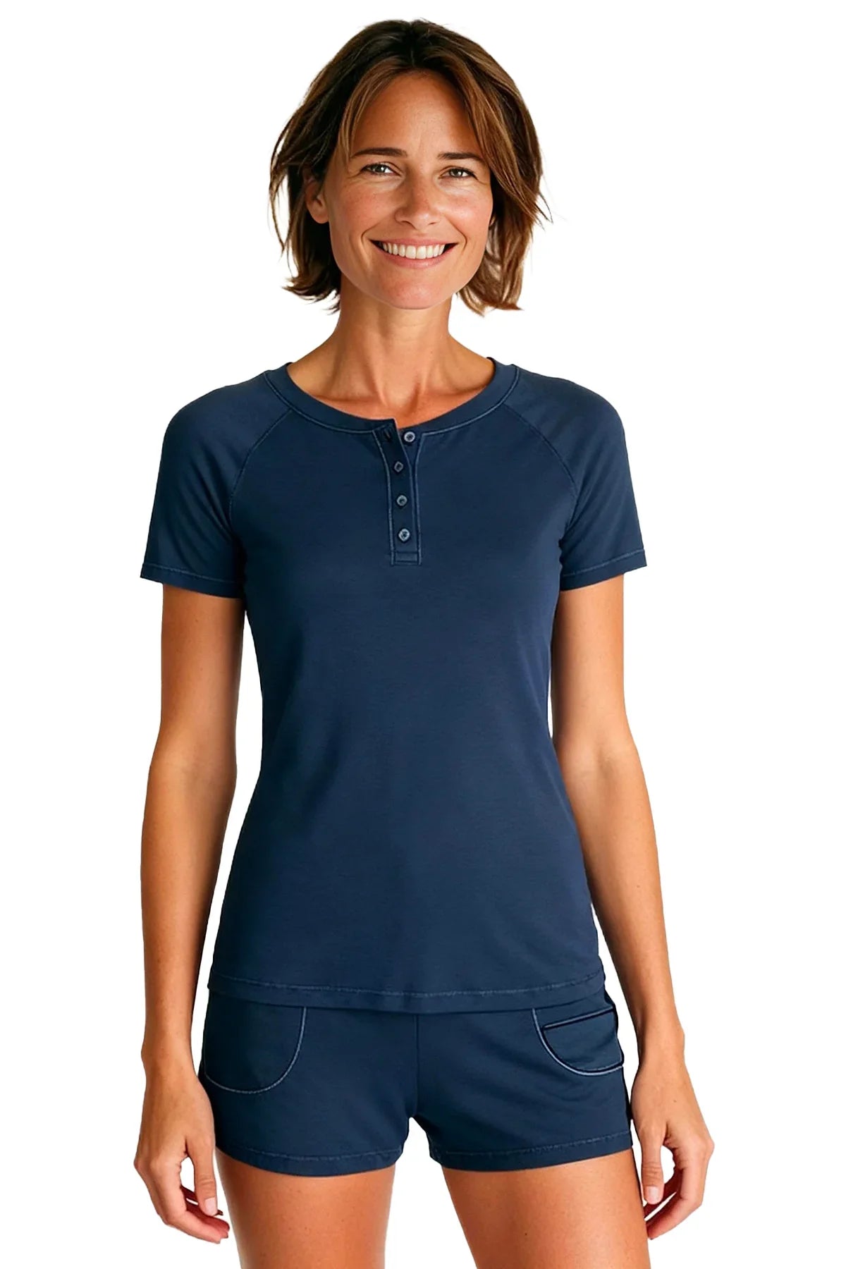 Smiling woman wearing steel blue short sleeve henley top and matching shorts on white background