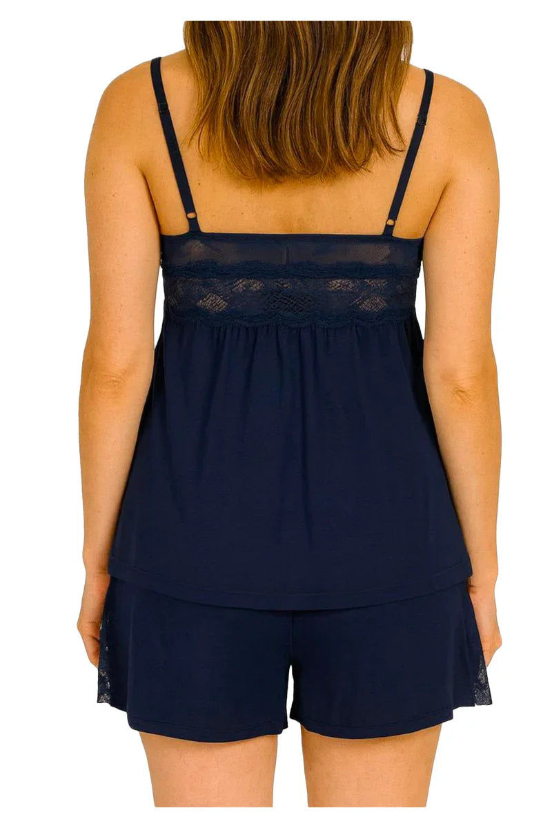 Back view of woman wearing navy blue lace trim camisole and shorts pajama set