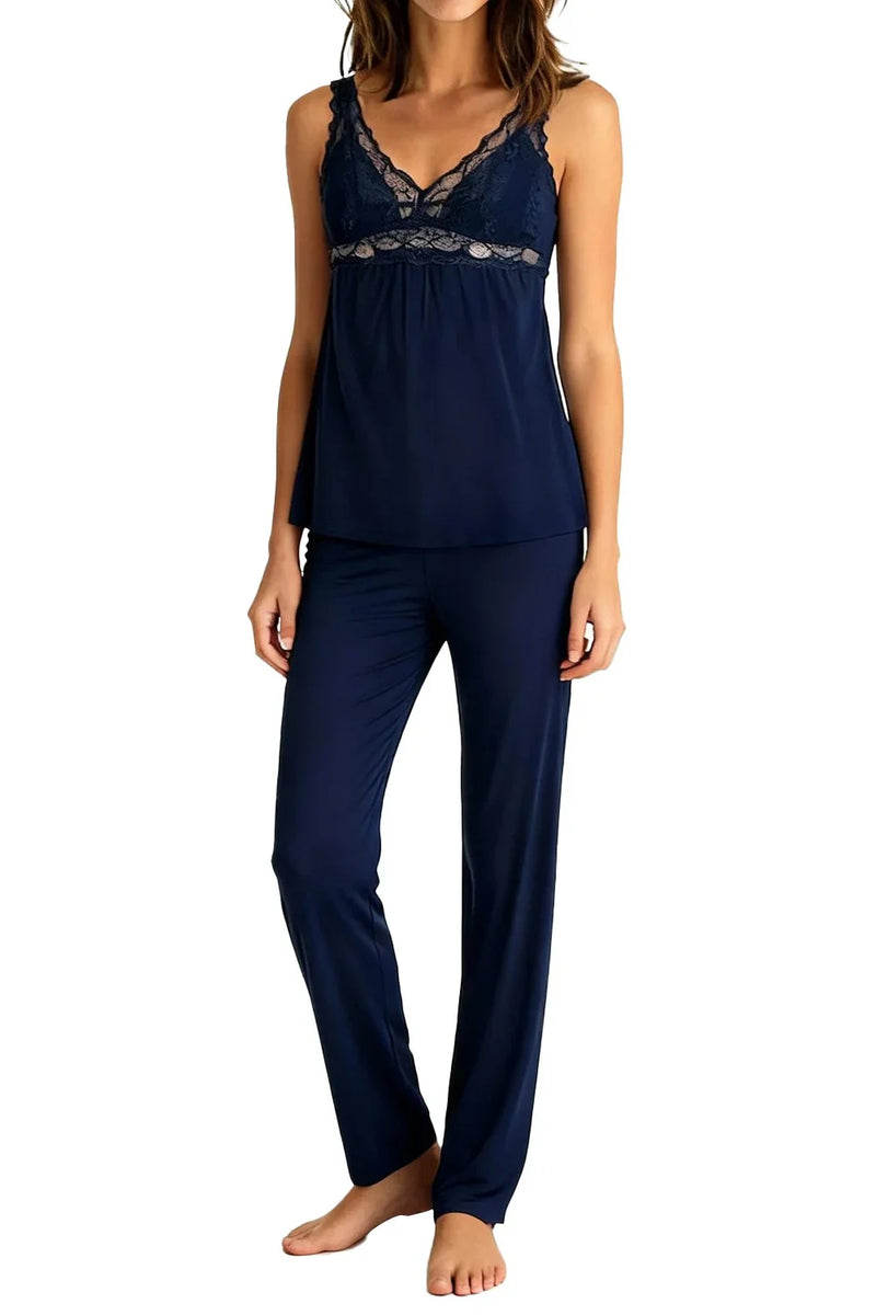 Woman wearing indigo navy blue lace-trim pajama set with sleeveless top and long pants