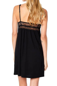 Back view of woman wearing black sleeveless dress with lace detailing and adjustable straps